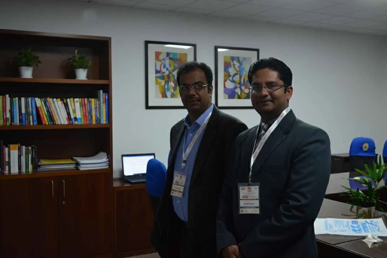 Two experienced professionals standing together in an office
