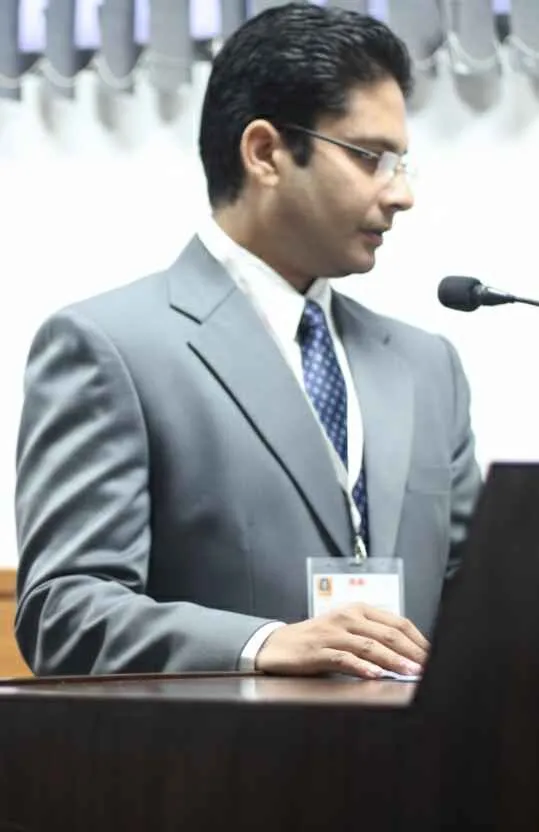Nitin Bhamri speaking at a lectern